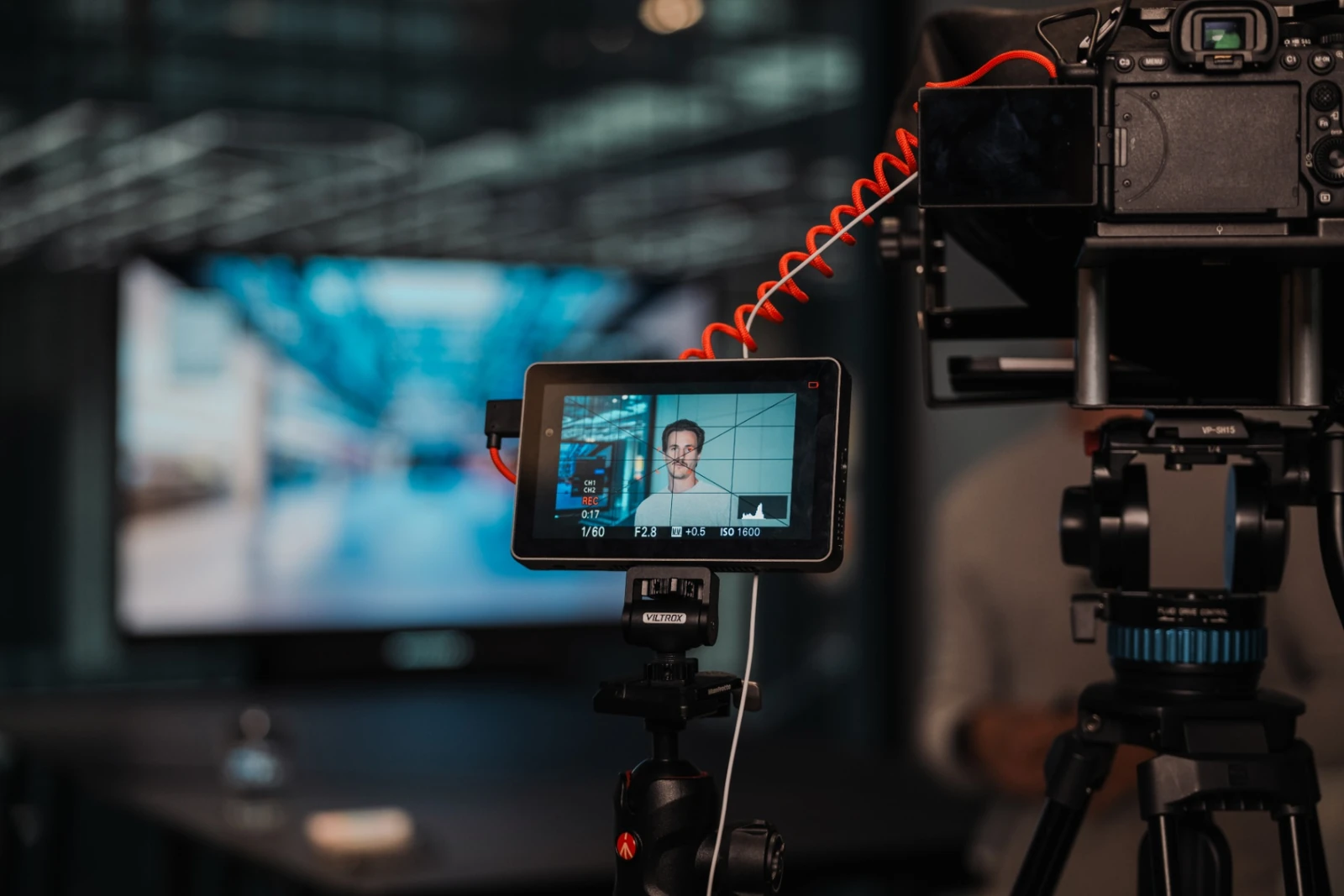 Camera monitor showing framed talent during a NextFlow Studios videography shoot in Munich