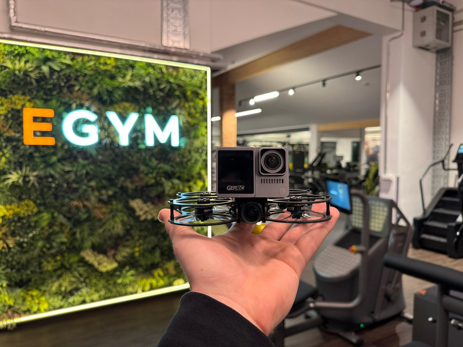249 g cinewhoop FPV drone with compact camera held in one hand for indoor and tight-space FPV cinematography